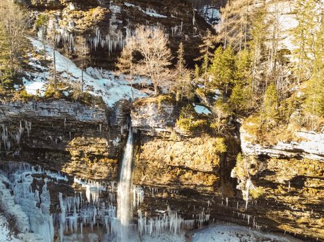 Aerial view of Pericnik slap or Pericnik Waterfall in winter time, Triglav National Park, Slovenia. Upper and lower waterfalls cascading over a rocky cliff, reachable by a picturesque walking trail