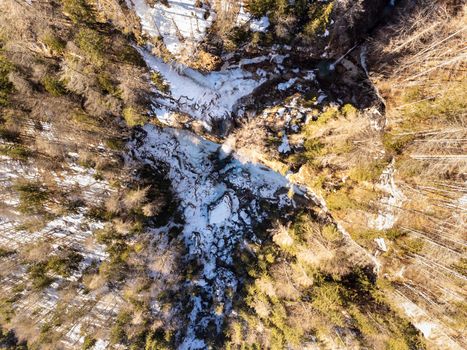 Aerial view of Pericnik slap or Pericnik Waterfall in winter time, Triglav National Park, Slovenia. Upper and lower waterfalls cascading over a rocky cliff, reachable by a picturesque walking trail