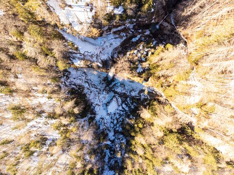 Aerial view of Pericnik slap or Pericnik Waterfall in winter time, Triglav National Park, Slovenia. Upper and lower waterfalls cascading over a rocky cliff, reachable by a picturesque walking trail