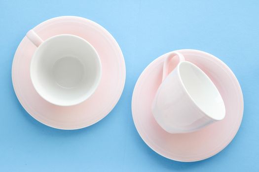 Kitchen, dishware and drinks concept - Empty cup and saucer on blue background, flatlay