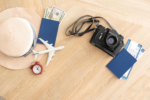 Travel concept. Airplane model, camera and passport on the table
