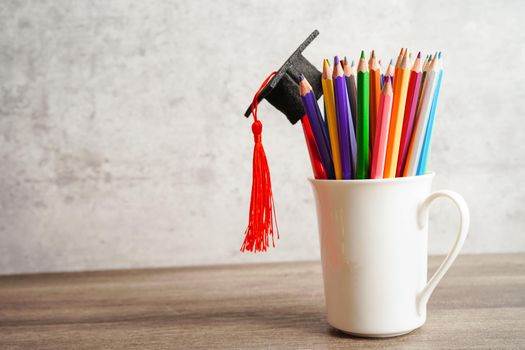 Colorful pencils in glass jar with copy space, learning university education concept.