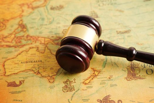Bangkok, Thailand - December 15, 2021 Judges gavel on ancient vintage world map, international law concept.