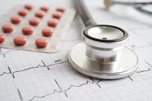 Stethoscope on electrocardiogram (ECG) with drug, heart wave, heart attack, cardiogram report.