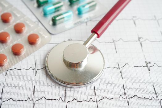 Stethoscope on electrocardiogram (ECG) with drug, heart wave, heart attack, cardiogram report.