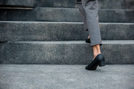 Stepping going up stairs in city, Closeup legs of businesswoman hurry up walking on stairway, rush hour to work in office a hurry in morning, foot of business woman wear black shoes step up success