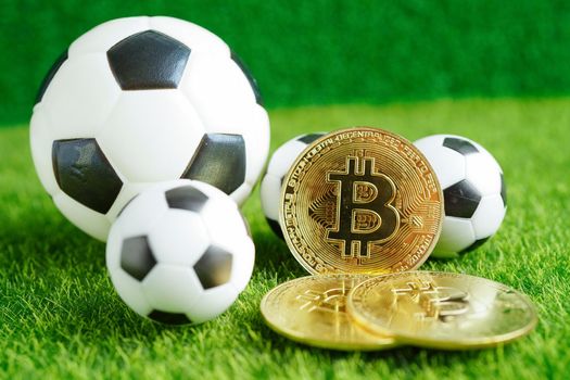 Gold bitcoin with soccer ball or football, cryptocurrency used in online sports betting.