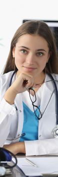 Portrait of woman doctor with glasses in her hands in clinic office. Medical consulting concept