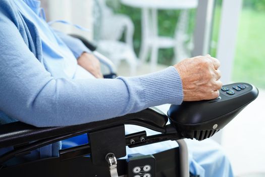 Asian elderly woman disability patient walk with walker in nursing hospital, medical concept.