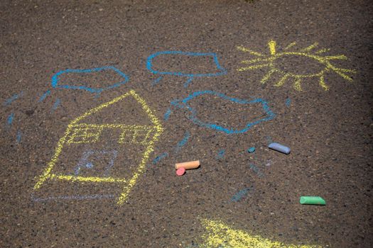 Children paint a rainbow on the asphalt. Selective focus. Kids.