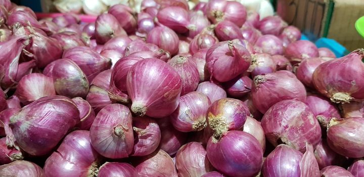 Group of Shallots onion Fresh purple shallots or Allium cepa, close up picture in the market