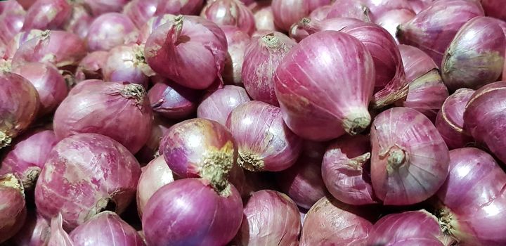 Group of Shallots onion Fresh purple shallots or Allium cepa, close up picture in the market