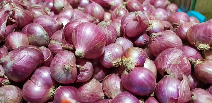 Group of Shallots onion Fresh purple shallots or Allium cepa, close up picture in the market