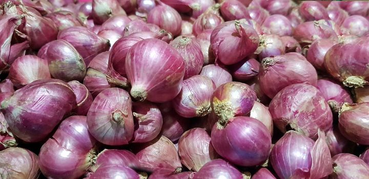 Group of Shallots onion Fresh purple shallots or Allium cepa, close up picture in the market