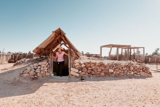 Emerging from an underground simple home built in hot desert of outback Australia