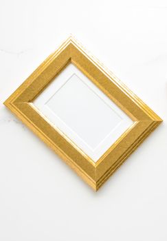 Golden photo frame on marble, flatlay - modern feminine, artwork mock up, luxury design concept. Decorate with chic and style