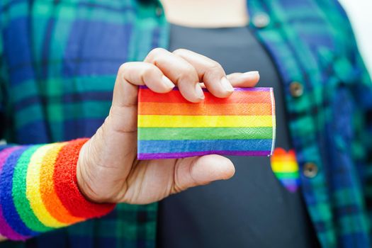 Asian woman with rainbow flag, LGBT symbol rights and gender equality, LGBT Pride Month in June.