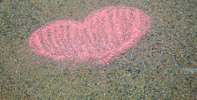 Children paint a rainbow on the asphalt. Selective focus. Kids.