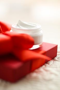 Beauty, cosmetics and skincare styled concept - Luxury face cream jar and red gift box