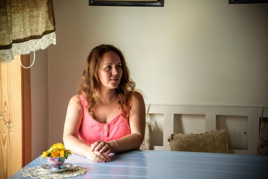 Enthusiastic Woman in trendy summer outfit chilling in cozy cafe, looking around , happy emotions. Traveling woman.