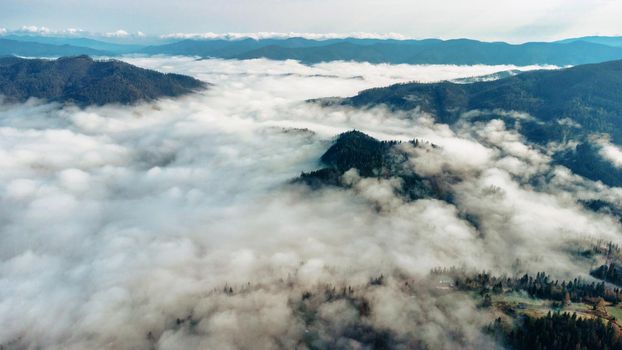 Scenery of mountains. A dreamy view of a foggy valley in the Carpathian mountains, Ukraine. Aerial panoramic drone shot download photo