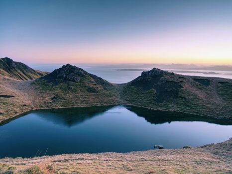 Small lake on the mountains and of Scottish Highlands. Scenic Landscape View of Mountain