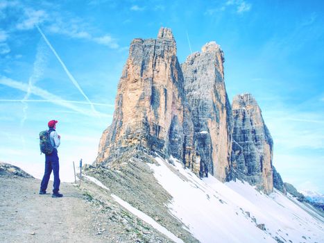 Traveler Man enjoying serene view Tre Cime mountains and landscape. Travel Lifestyle hiking concept summer vacations outdoor