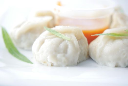 close up of chicken momo dumpling on a plate .
