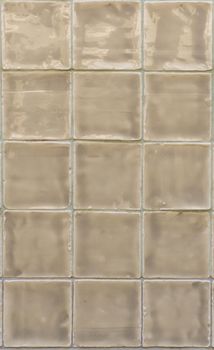Glossy beige tiles close up background