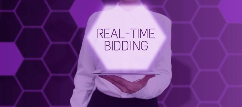 Writing displaying text Real Time Bidding, Concept meaning Buy and sell advertising inventory by instant auctions Lady in suit holding pen symbolizing successful teamwork accomplishments.