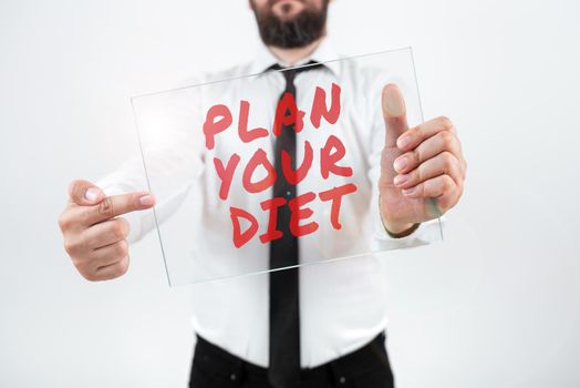 Conceptual caption Plan Your Diet, Word for Schedule fitness activities and meals to lose weight Businessman Checking Circle Button Of The Blue Glowing Technology System.