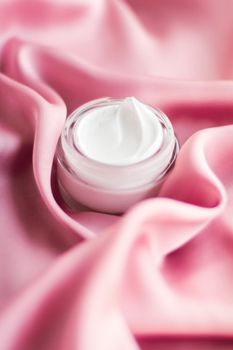 Beauty, anti-age cosmetics and skincare concept - Luxury face cream jar on a soft pink silk