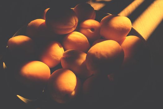 Delicious ripe apricots with hard light. horizontal photo