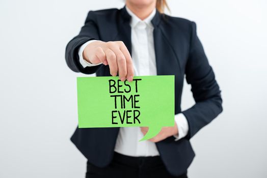 Sign displaying Best Time Ever, Conceptual photo Be excited for what is happening at the moment Cheerful Businesswoman In Suit Holding New Important Message Between Hands.