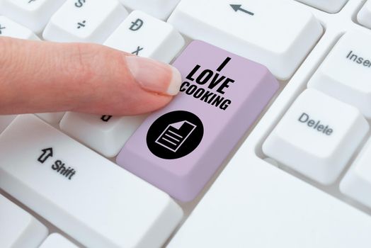 Hand writing sign I Love Cooking, Conceptual photo Having affection for culinary arts prepare foods and desserts Important Messages On Notebook And Lap Top On Desk With Office Supplies.