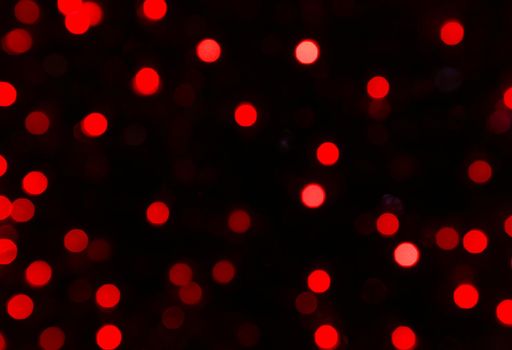 festive bokeh of red lamps at night. Blurred bokeh of festive garlands at night.