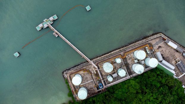 Aerial view from drone of terminal storage tank, Iindustrial facility for storage of oil and petrochemical. Business commercial trade fuel energy transport by tanker ship vessel.