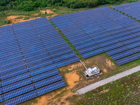 Aerial view of solar panels on a sunny day. A large photovoltaic plant in northern Thailand. Electric farms produce clean energy.