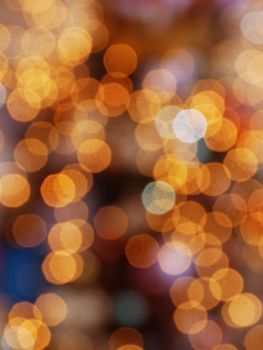 Yellow blurred shimmering Christmas lights. Abstract yellow background of soft blurry christmas lights garlands.