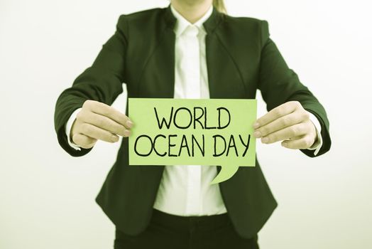 Hand writing sign World Ocean Day, Concept meaning Worldwide celebration for big bodies of salt water Businessman Holding Mobile Phone And Speech Bubble Popping Out With Ideas.