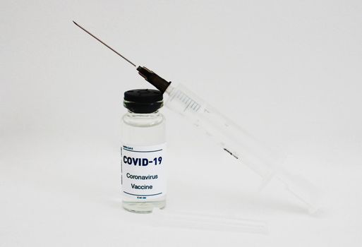 Needle from a syringe inserted into a vial of the Covid-19 vaccine.