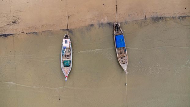 Many fishing boats near the seashore in tropical islands. Pier of the villagers on the southern island of Thailand. top view from drones.