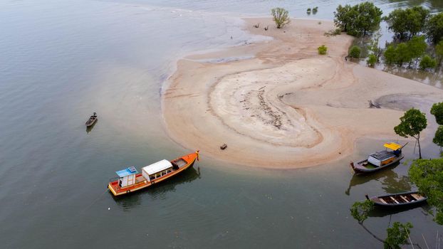 Aerial view of small boats on the beach with mangrove forest in Ao Thalane, Krabi, Thailand.