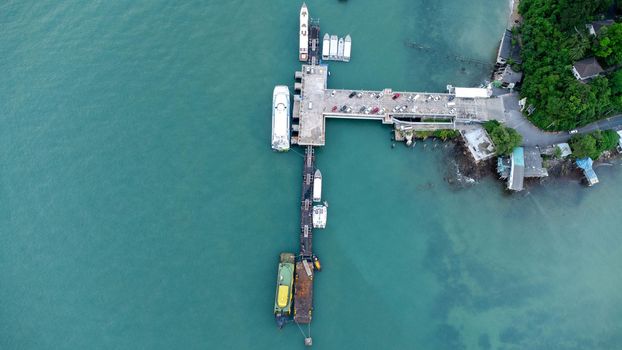 Aerial view from drone of commercial ship and cruise ship parked in the marina. Transportation and travel background, beautiful sea in summer.