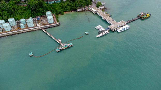 Aerial view from drone of commercial ship and cruise ship parked in the marina. Transportation and travel background, beautiful sea in summer.