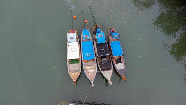 Aerial view of Thai traditional longtail fishing boats at the pier. Transportation and travel concept.
