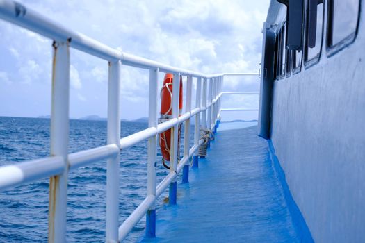The deck of the ferry sails across the Andaman Sea on a hot summer day. Tropical sea views from the passenger ferry deck. Travel and transportation concept