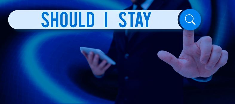 Text sign showing Should I Stay, Business overview Looking for reasons to remain on a place Doubtful Indecision Lady in suit holding pen symbolizing successful teamwork accomplishments.