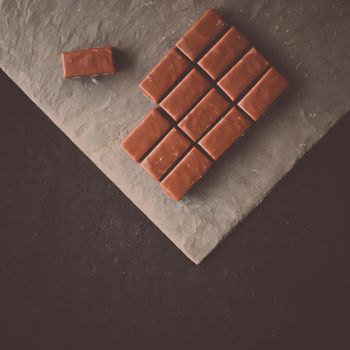 Sweet swiss chocolate candies on a stone tabletop, flatlay - desserts, confectionery and gluten-free organic food concept. All you need is chocolate