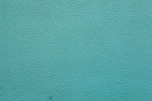 Surface of old worn blue green paint on wall.